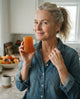 Customer in her kitchen holding the aki bar